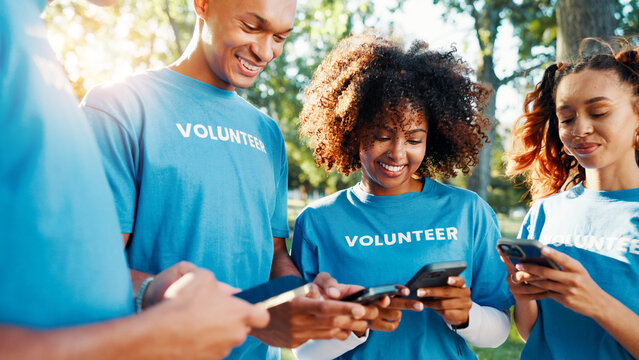 Volunteers, charity and people with phone, outdoor and communication for fundraising event or online. Happy, social responsibility and group with tech for donations, browsing and community service