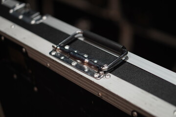 Black suitcase with silver handles for stage equipment