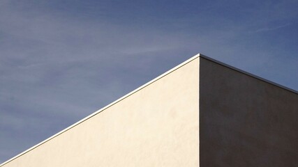 corner of white building against the sky