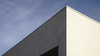 corner of white modern house against blue sky