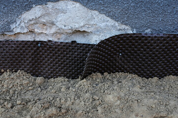 Waterproofing of foundation walls, plastic backingю House foundation waterproofing. Installation...