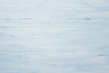 A textured light blue wooden background with a rustic, weathered surface for graphic design projects