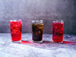 A lot of Soft drinks in colorful and flavorful glasses on the table,Glasses with sweet drinks with ice cubesv