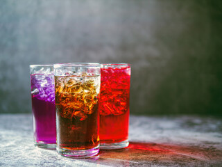A lot of Soft drinks in colorful and flavorful glasses on the table,Glasses with sweet drinks with ice cubesv