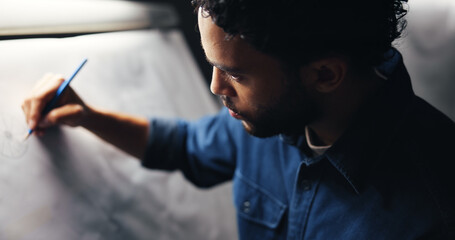 Sketching, creativity and man artist in studio at night with deadline for animation illustration. Board, equipment and male graphic designer drawing for visual character prototype at agency in dark.