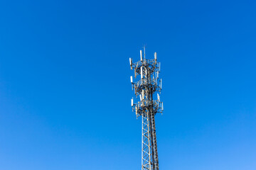 Communication signal tower with blue sky background