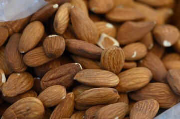 Freshly harvested almonds piled together in a natural display showcasing their rich texture and earthy hues