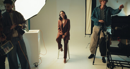 Photography, portrait and smile with model in studio for catalog or magazine photoshoot. Backstage, creative or media with happy woman on set for advertising, marketing or production campaign