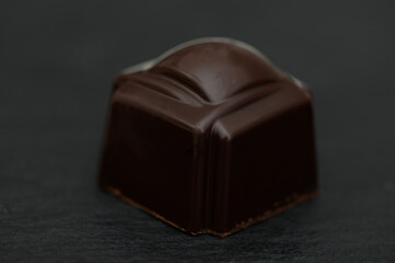 Indulging in rich dark chocolate confection crafted by artisanal hands, showcasing exquisite...