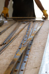 Blacksmith assembling a metal structure for a fence	

