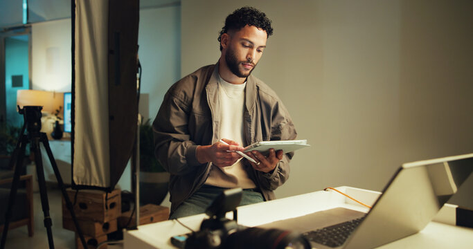 Man, studio and photographer with tablet planning on set for creative, branding and career. Media photoshoot, production and person with photography behind the scenes for magazine cover with agency