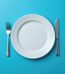 Setting the Table with White Plate Knife and Fork on Blue Surface