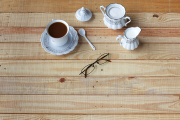 Elegant Coffee Setup with Creamer, Sugar, and Glasses on Wood Table