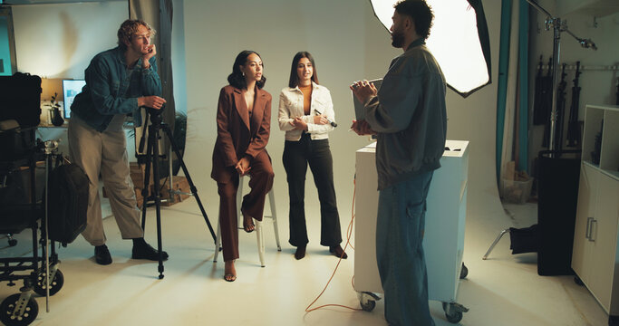 Photographer, review and tablet with people in studio together for discussion, photoshoot or planning. Backstage, creative or media with makeup artist, model and photography on set for collaboration