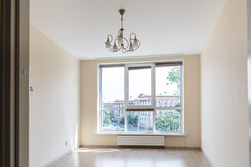 a bright unfurnished bedroom with a large window 