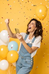 Fototapeta premium Excited Woman Celebrates Online Success with Mobile Phone 