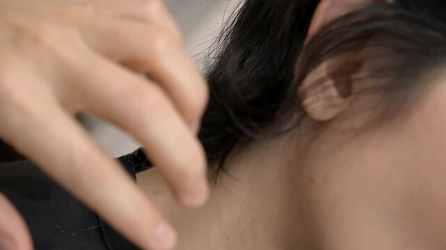 Close Up Hand and Scissors Cutting Hair of Brunette Woman