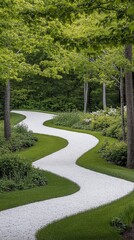 Fototapeta premium Winding gravel path through lush green garden