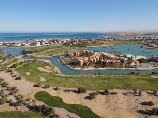 Beautiful drone overview of big golf course with lakes by tourists town El Gouna in The Red Sea, Egypt