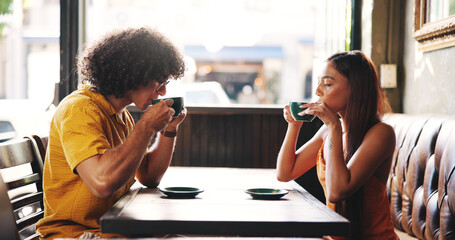 Cafe, couple and date with coffee to drink, bonding together and connection with espresso. Restaurant, woman or man with tea for romance, conversation or beverage for caffeine in healthy relationship