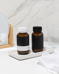Two blank vitamin supplement amber bottles on bathroom counter