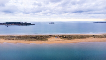 A long sand dune, and the Atlantic Ocean. Bay of Santander, Cantabria, Spain.