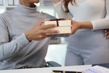 A young Asian couple expresses their love by surprising each other with gifts. Feel the sweet smiles and love of a newly married Asian couple.