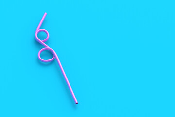 One curved drinking straw on blue background. Plastic tube for beverage. Copy space. 3d render