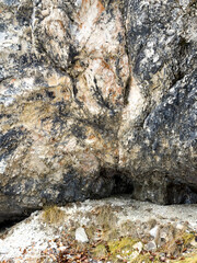 natural rock formation with intricate textures and earthy tones with small caves. rugged landscape. natural concept. abstract background, texture. geological