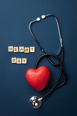 Red heart with doctor stethoscope and the inscription heart day on blue background, hospital life...