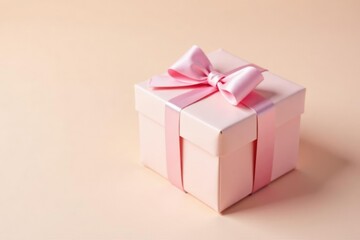 Obraz premium Pastel pink present box on a cream background, gentle gift, box, pastel gift