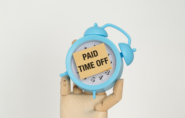 A blue alarm clock with a note on it that says Paid Time Off