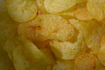 Crispy golden chips scattered joyfully on a bright background celebrating snack time during a sunny afternoon