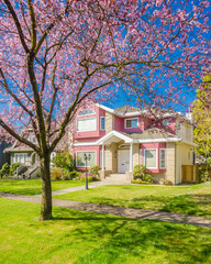 Obraz premium Two story luxury house with beautiful summer landscape in Vancouver, Canada, North America. Day time on June 2024