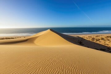 Golden Sand Dune Coastal Landscape Wind Blown Sand And Sandy Beach With Ocean Background Captivating Scene Showcasing Winds Artistry On Sandy Beach With Golden Sand Textures Coastal Beauty