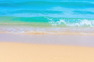 Captivating Close Up Gentle Waves Breaking On Sandy Shores Bright Turquoise Water And Foamy Crests Under Sunny Sky Beach Scene Reflecting Natural Light And Ocean Beauty