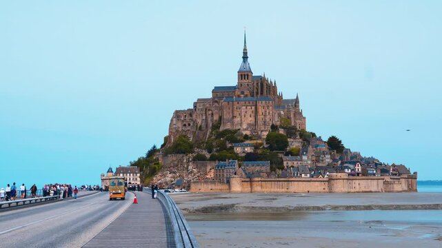 Scenic view of the island - fortress Mont Saint Michel with a Mont-Saint-Michel Abbey in the evening at low tide of the Atlantic Ocean. Department Manche, Normandy region, France