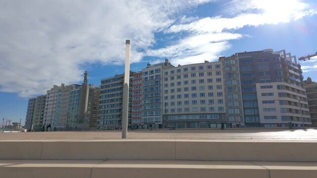 Ostend, West-Flanders, Belgium, November 26th, 2025, A stunning view shows modern architecture against a vibrant blue sky with fluffy white clouds overhead