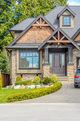 Entrance of grey painted luxury house in summer with stair steps and nice landscape in Vancouver, Canada, North America. Day time on June 2024