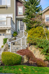 Entrance of grey painted luxury house in summer with stair steps and nice landscape in Vancouver,...