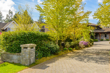 Entrance of grey painted luxury house in summer with stair steps and nice landscape in Vancouver,...