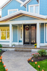 Entrance of grey painted luxury house in summer with stair steps and nice landscape in Vancouver,...