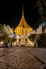 watphraphutthabat-saraburi  : The resplendent golden temple shimmers against the dark, creating an atmosphere of serene beauty, inviting exploration and contemplation. A beacon of culture. 