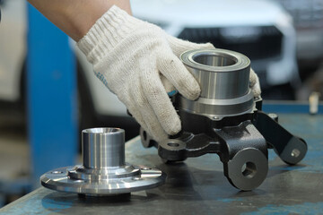 Repairs at a car service station.New spare parts.Control of new car suspension parts, the...