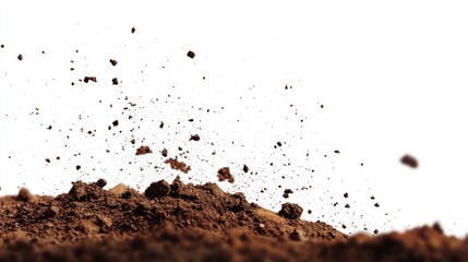 Soil being disturbed and flying into the air, showcasing the texture and movement in a bright background