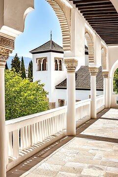 Stunning view of an ornate archway leading to lush greenery, showcasing architectural beauty and tranquility in bright sunlight.