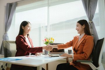 Businesswoman analyzes financial data in modern office, reviews charts and reports, plans investment strategies, and discusses growth opportunities with colleagues to drive organizational success.