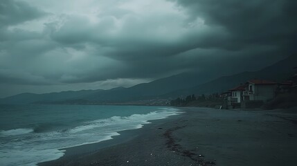 Deserted beach with dark clouds gathering in the sky signifying an approaching storm over the tranquil seashore