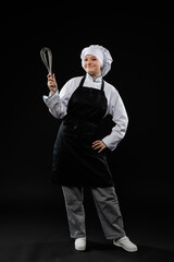 Professional Chef Holding Whisk in Black Apron