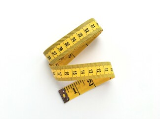 Folded yellow measuring tape on white background